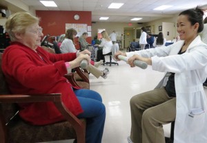 Elant at Fishkill resident, Josephine Enzerillo, doing an upper body strength exercise with SUNY Orange OTA student, Josephine Pierro.