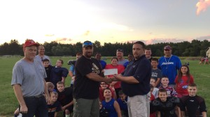 Jeff VanWagenen (right), manager United Water Owego Nichols, presents a check to Adam Cole (center), vice president of the Owego Junior Football League, and Tom Taft (left), president of the league.